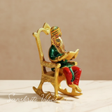 Modern Chair Ganesha Metal Statue Reading Ramayan with Meenakari Work Aluminium Ganesh Showpiece for Home Decor and Auspicious Gifting - Retail Maharaj