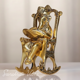 Metal Ganesha Sitting on Moving Chair Reading Ramayan – Handcrafted Ganpati Decorative Statue for Home & Office (Glossy Finish, Made in India)