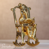 Metal Ganesha Sitting on Moving Chair Reading Ramayan – Handcrafted Ganpati Decorative Statue for Home & Office (Glossy Finish, Made in India)